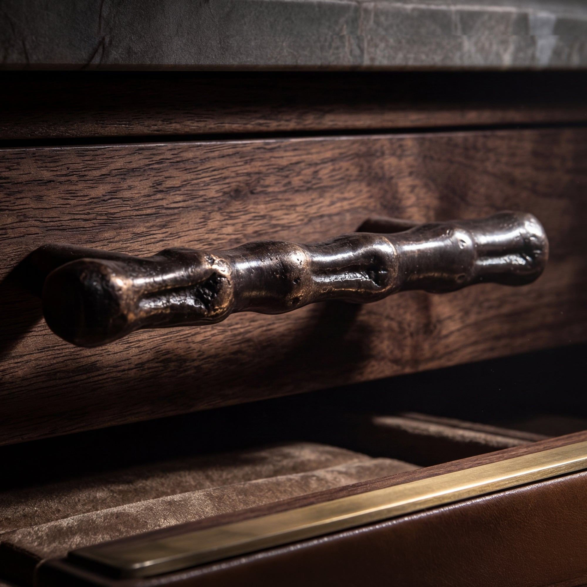 Handcast bronze cabinet hardware shown on refined cabinetry for kitchens, built-ins, and architectural interiors.